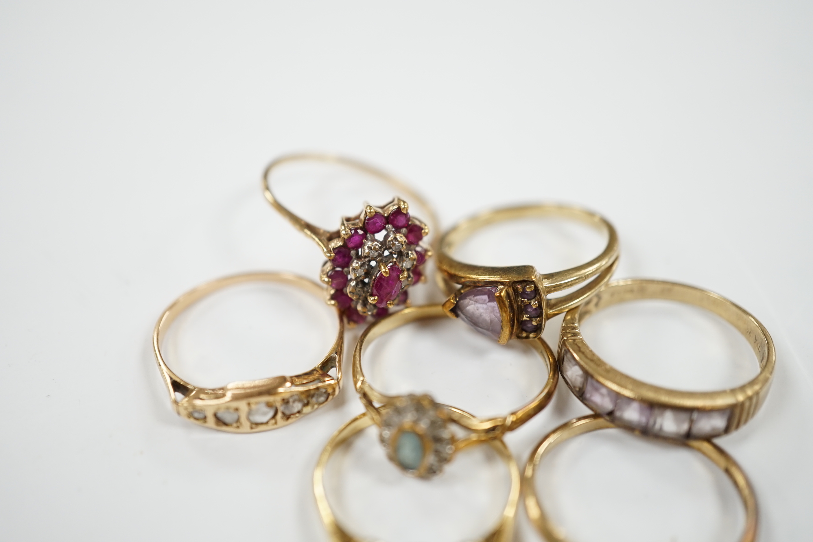 Seven assorted mainly modern 9ct gold and gem set dress rings, including three stone diamond and five stone diamond, gross weight 15.7 grams.